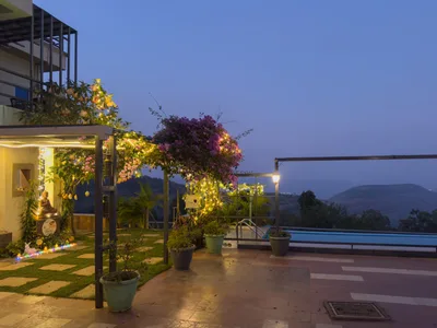 Twilight pool deck and illuminated pergola at Meraki Villa